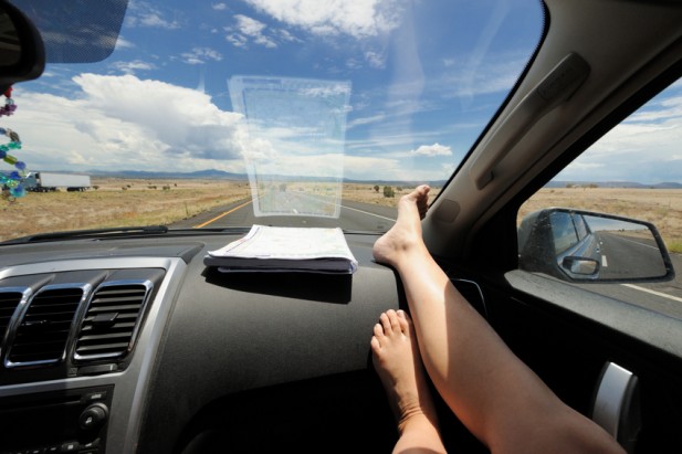 a person's feet on a car dashboard