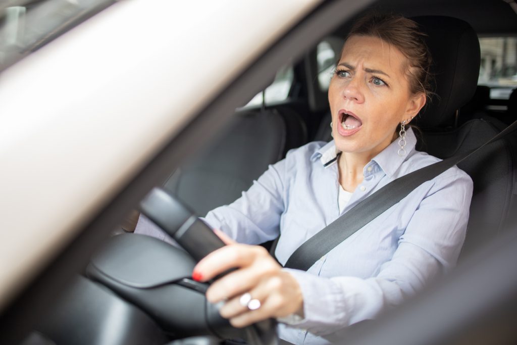 Woman is driving a car